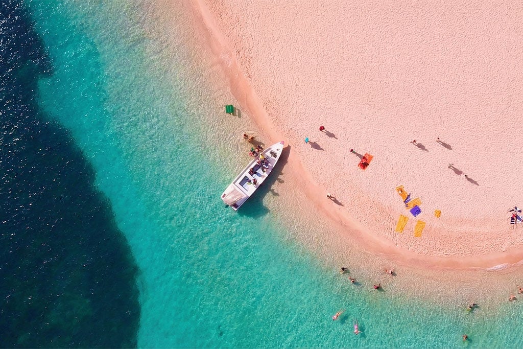 Aerial view of Hurghada beach with boat and sunbathers Egypt tour package, egypt holiday packages