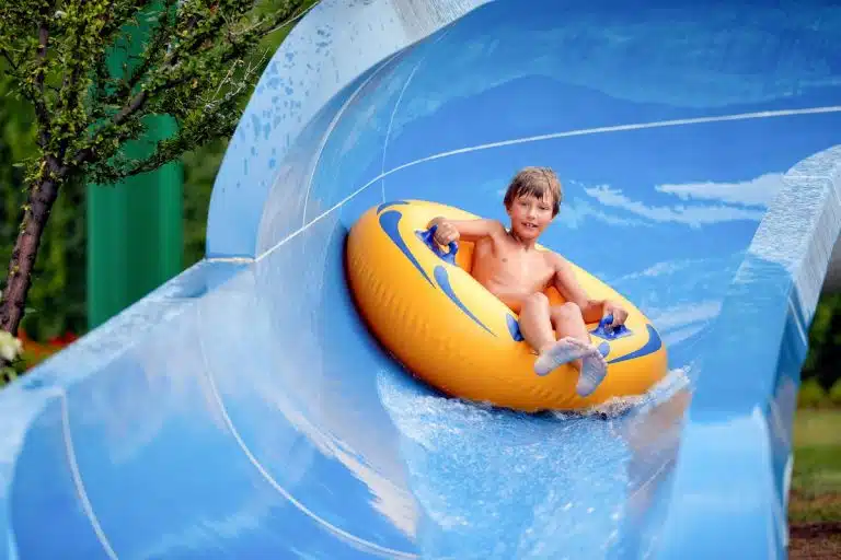 Child sliding down a water slide at Aqua Park Hurghada, Hurghada water park with transfers