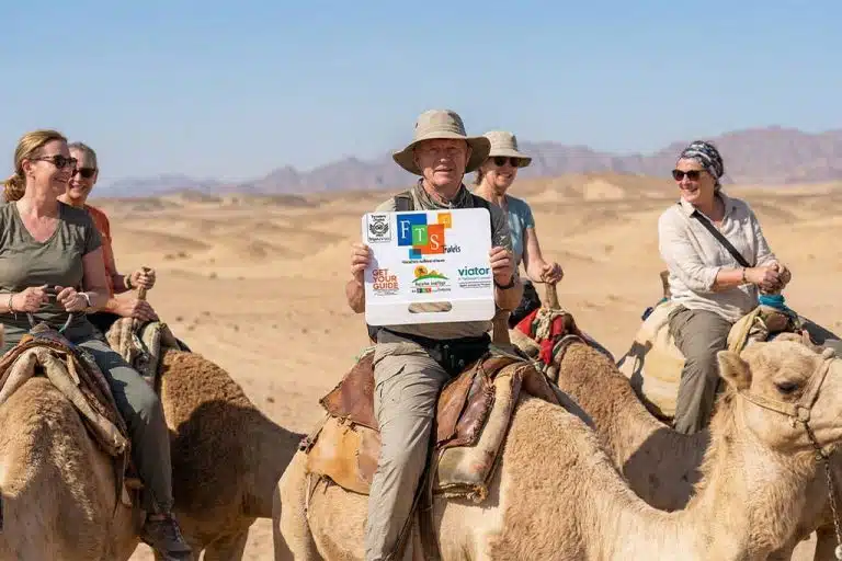 Group enjoying a camel ride atv tour hurghada