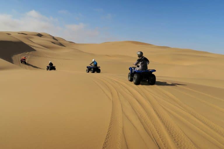 in the desert during a Hurghada adventure, quad biking, camel ride