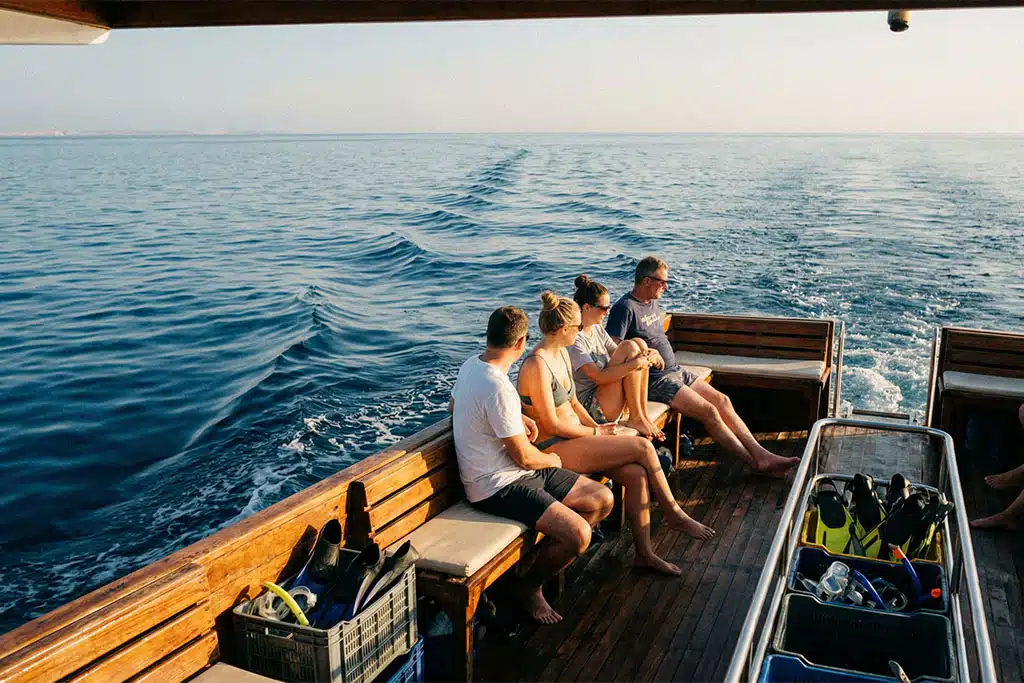 Group enjoying a scenic boat ride dolphin tour hurghada, coral reef snorkeling