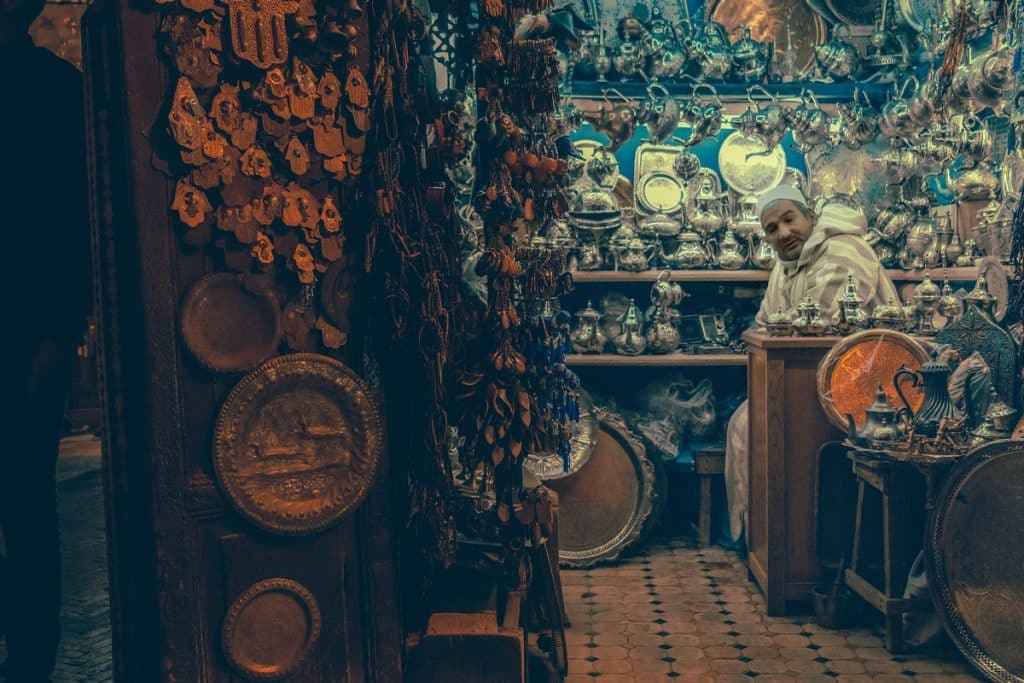 Vendor in market surrounded by crafts khan khalili, khan al khalili