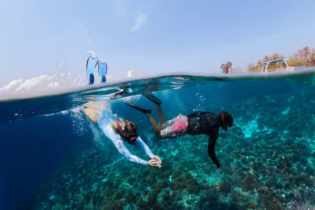 Two snorkelers exploring the underwater beauty el gouna day trip, el gouna activities