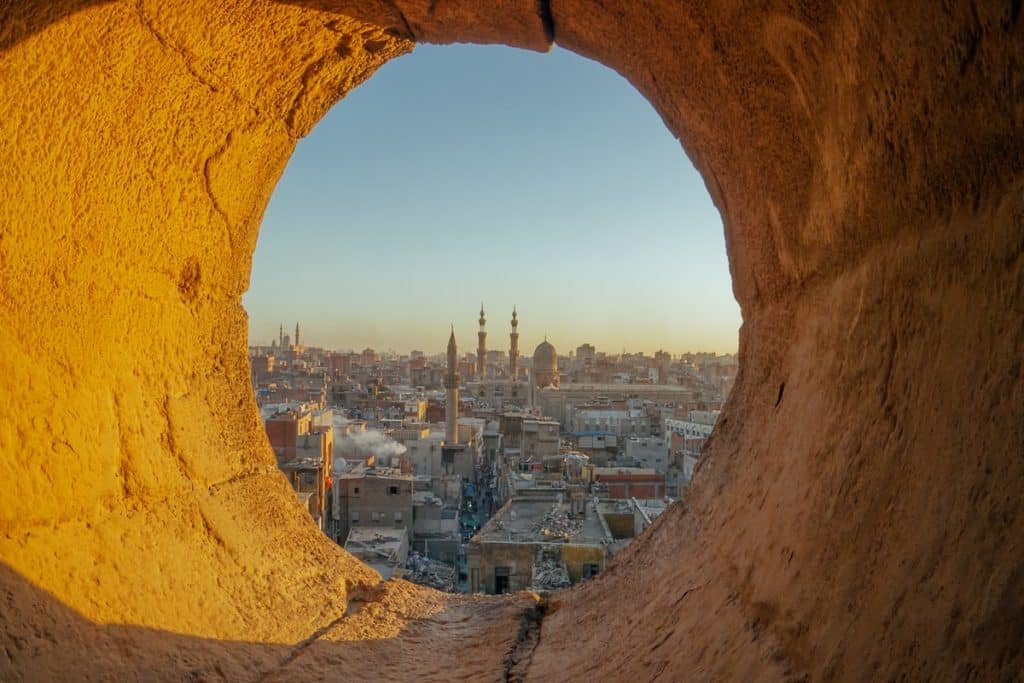 View of Cairo cityscape through an ancient arch, marsa alam excursions, marsa alam tours