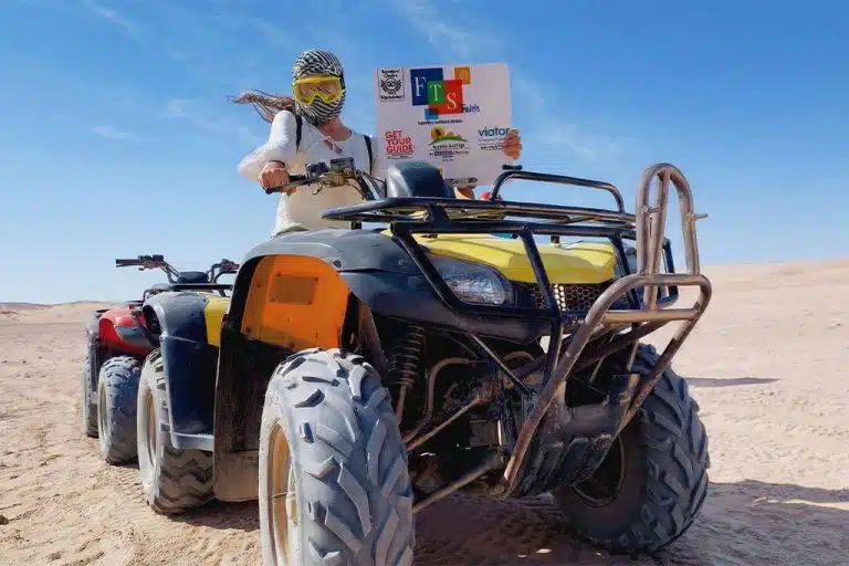 A person riding a quad bike in the desert quad biking hurghada