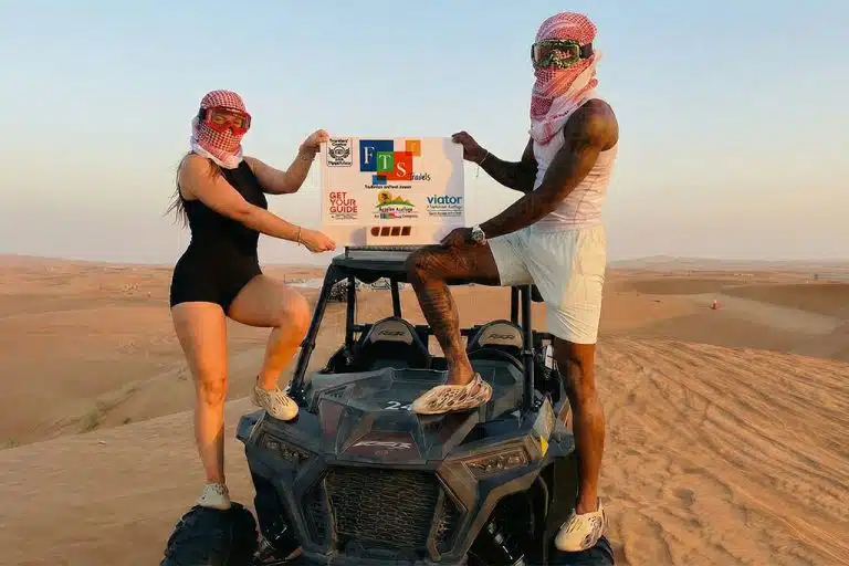 Two adventurers pose on a quad bike in the desert quad biking hurghada