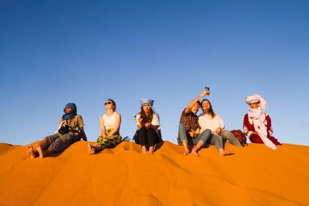 Travelers relaxing on golden dunes hurghada quad biking, hurghada buggy safari