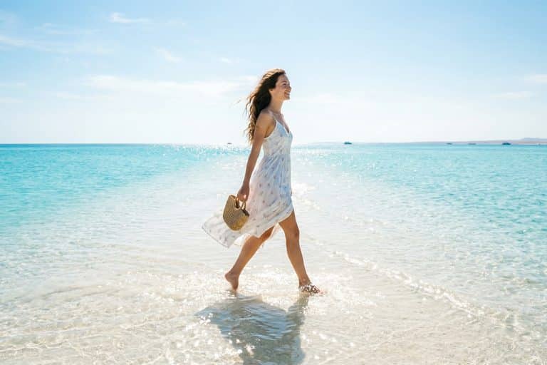 Woman walking on the beach at Ras Mohamed snorkel rental near me, snorkeling trip