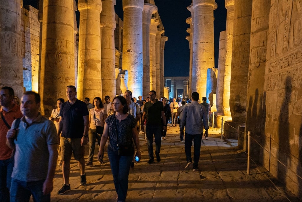 Visitors walking through the illuminated Karnak temples Luxor temples, karnak and luxor temples