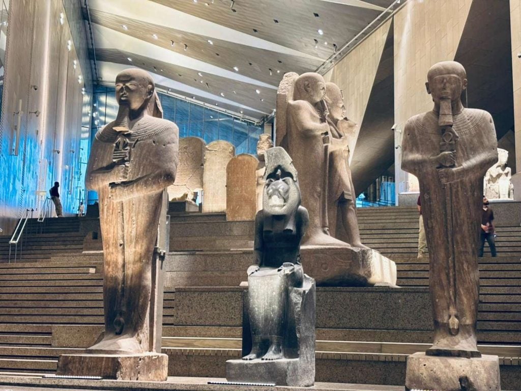 Large ancient statues displayed in the Grand Egyptian Museum